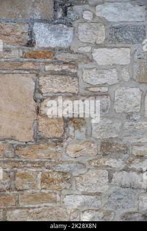 Irregular and brown stone wall texture Stock Photo