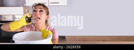 Water Leak Ceiling Damage Calling Plumber. Domestic Emergency Stock