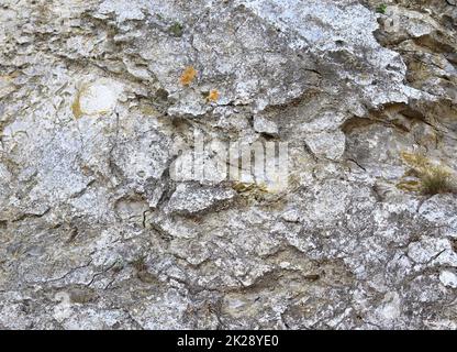 Close up view at a natural limestone wall in the mountains. Stock Photo