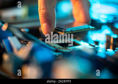 Motherboard Microchip In Hand. Computer Testing Stock Photo