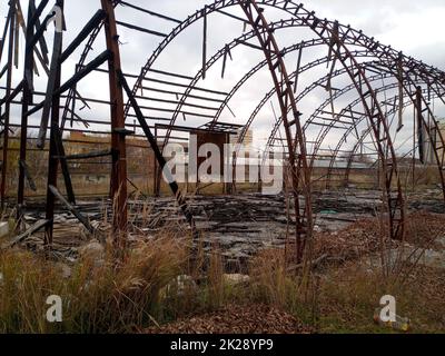 Burned hangar. frame of the hangar after the fire. everything burned down. Stock Photo