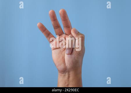 Office syndrome concept. Index finger is stretched after working. Close up shot isolates on blue background. Stock Photo