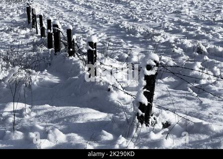 Barbed wire fence with snow Stock Photo