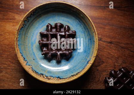Chocolate waffle in handmade clay plate Stock Photo
