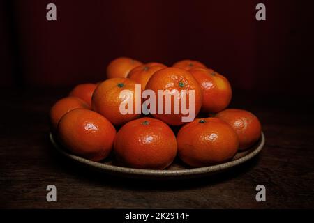 Mandarin oranges on plate dark backround Stock Photo