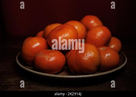 Mandarin oranges on plate dark backround Stock Photo