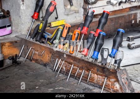 Screwdrivers and other tools in the car garage Stock Photo
