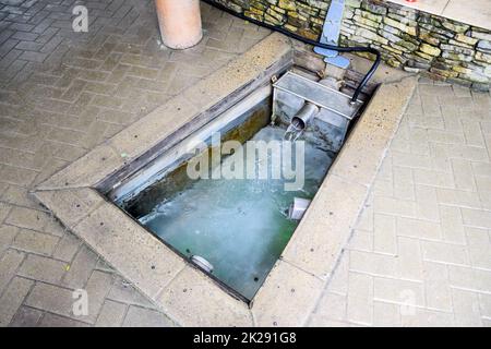 A small swimming pool with holy water from the spring. A niche in the floor for recruiting water from a source Stock Photo