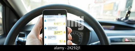 Phone Texting While Driving. Man Using Mobile Phone Stock Photo
