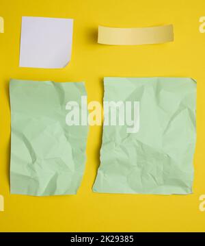 various torn pieces of paper on yellow background Stock Photo