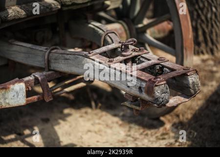 Detail on old rusty wooden wagon connecting mechanism. Stock Photo
