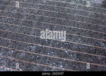 Drops of water on rear car window, heating stripes visible. Stock Photo