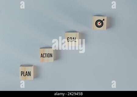 Wooden cubes with plan action goal symbol on background and copy space.Business concepts. Stock Photo