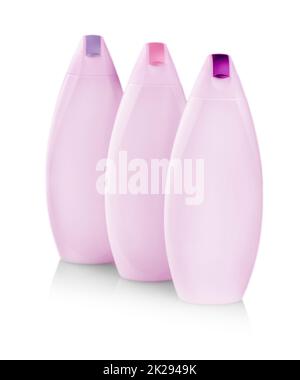 pink plastic bottles with colored capes of body care and beauty products. Studio photography of plastic bottle for shampoo - isolated on white background Stock Photo