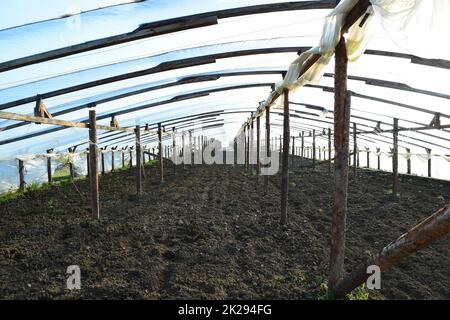 Greenhouses made of polymer film. Early spring in the garden greenhouses Stock Photo