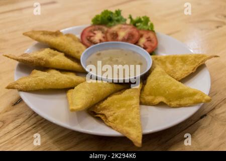 Thai food with cheese, sauce and salad. Snacks in Phuket. Stock Photo