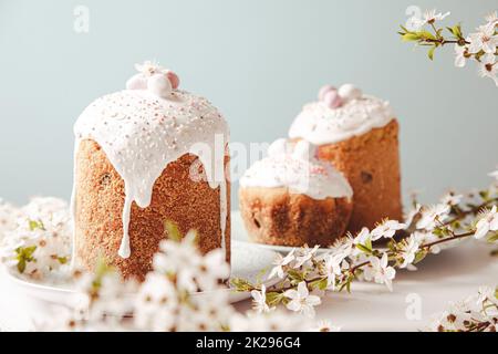 Easter cake with glace icing and decoration. Postcard with Easter bread. Christian traditions. Copy space. White background. Stock Photo