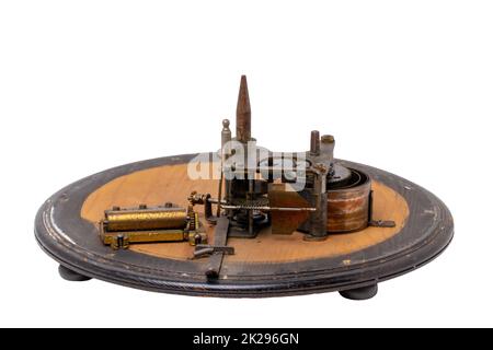 Inside the antique revolving Christmas tree stand the mechanism for playing two Christmas carols consisting of roller mechanism with music box and spring drive. Clipping path. Stock Photo