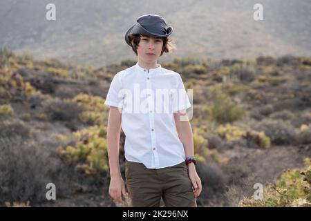 Portrait of a teenager against the backdrop of the Los Gigantes cliffs. View from cape Teno. Tenerife. Canary Islands. Spain. Stock Photo