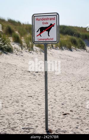 On the beach, dog beach on the Baltic Sea is a sign which marks the area of the dog beach. Stock Photo