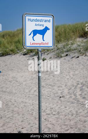 On the beach, dog beach on the Baltic Sea is a sign which marks the area of the dog beach. Stock Photo