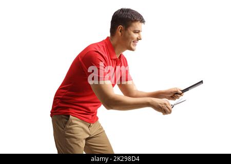 Profile shot of a male hairdresser holding scissors and a hair comb isolated on white background Stock Photo