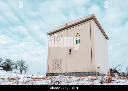Outdoor electric high voltage distribution cabinet in a snow Stock Photo