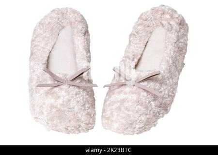 Slippers isolated. Close-up of a pair of female beige warm and soft cosy terry slippers isolated on white background.  Womans shoes. Stock Photo