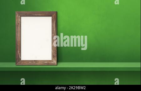 Wooden picture frame leaning on a green shelf. 3d illustration. Horizontal banner Stock Photo