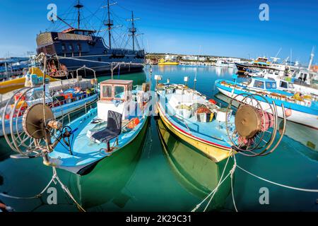 Tourist 'Pirate ship' and moored fishing boats in harbour at Ayia Napa. Famagusta District. Cyprus Stock Photo