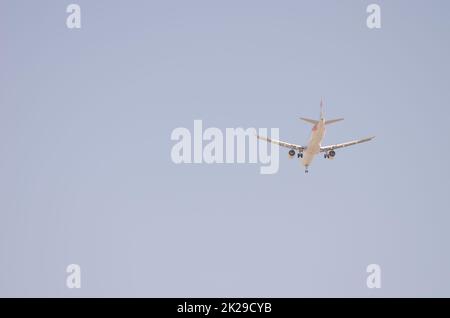 Underside view of an airplane in flight. Stock Photo