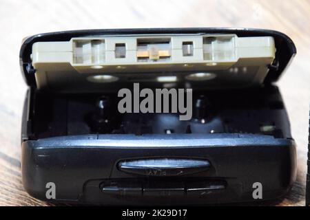 Retro audio cassettes next to a portable player to play compact cassettes. Stock Photo