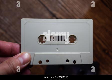 audio cassette in the hands of a man. Retro audio. Stock Photo