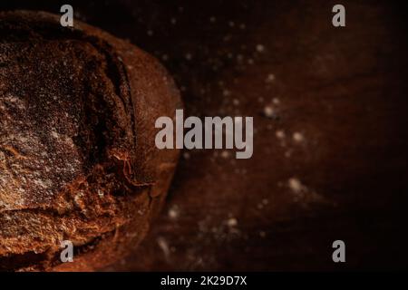 freshly baked organic bread on wooden table in bakery Stock Photo