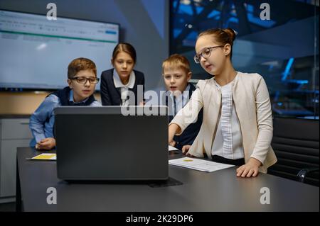 Diverse children business team analyzing financial data Stock Photo