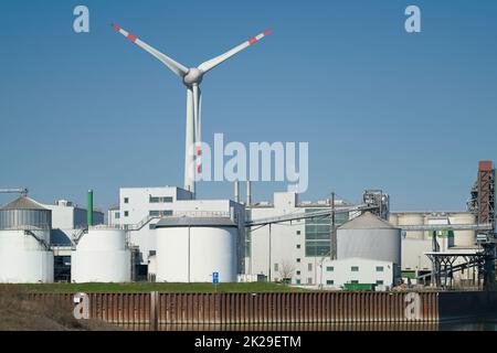Industrial plant and wind turbine in the Port Kanalhafen of Magdeburg on the river Elbe Stock Photo