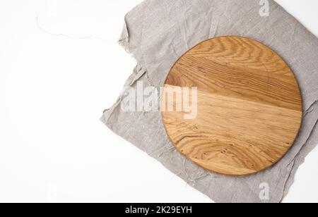 empty round wooden cutting kitchen board on a white background, pizza board, copy space Stock Photo