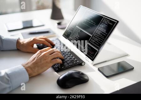 Computer Programmer Writing Program Code On Computer Stock Photo