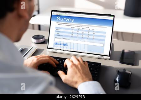 Businessperson Filling Online Survey Form Stock Photo