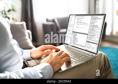 Computer Programmer Writing Program Code On Computer Stock Photo