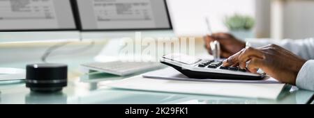 Bookkeeper Accountant Calculating Tax Invoice Stock Photo