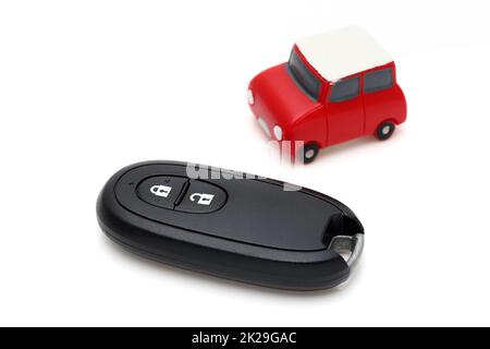 car black key remote controller and small toy car on white background Stock Photo