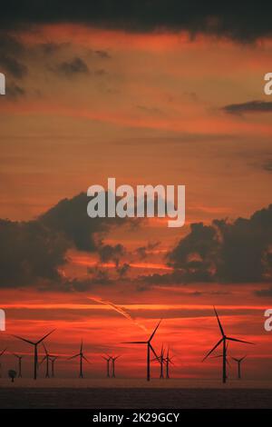 Sky over Baltic Sea wind farm at sunset Stock Photo