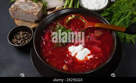 Traditional Ukrainian Russian borscht . Bowl of red beet root soup borsch with white cream . Beet Root delicious soup . Traditional Ukraine food cuisine Stock Photo