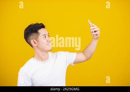 happy male taking selfie on smartphone Stock Photo