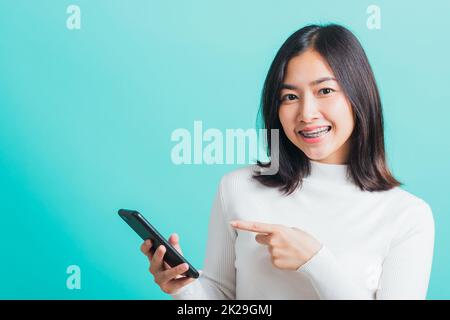 woman smile she holding and typing text message