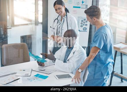 Teamwork, innovation and doctors collaboration in meeting in conference room, happy and planning on breakthrough medical success. Diverse, healthcare Stock Photo