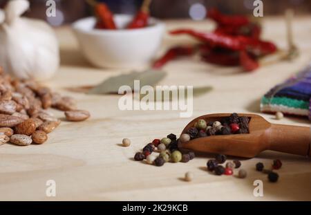 Burlap Sack of Pinto Beans on Table with Spices in Background Stock Photo