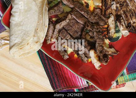 Beef and Chicken Fajita Meal on Table With Rice and Tortillas Stock Photo