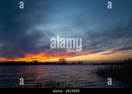 Colorful clouds after sunset on the lake Stock Photo